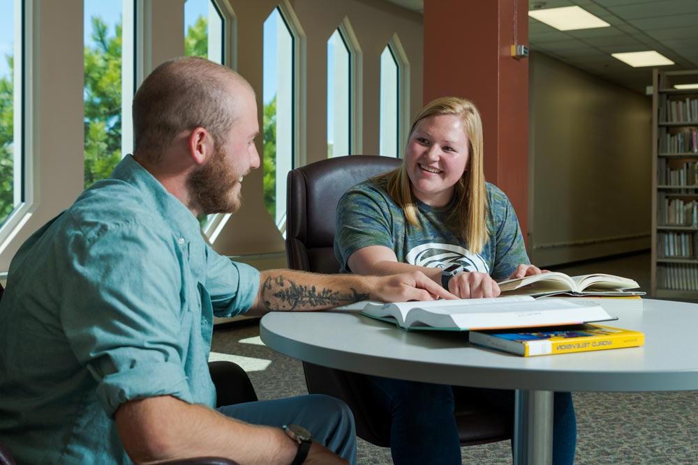 Two students reviewing material in the King Library